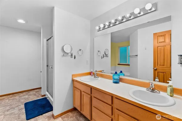 a bathroom with a sink double vanity granite and a mirror