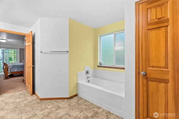 a view of a bathroom with a tub and shower