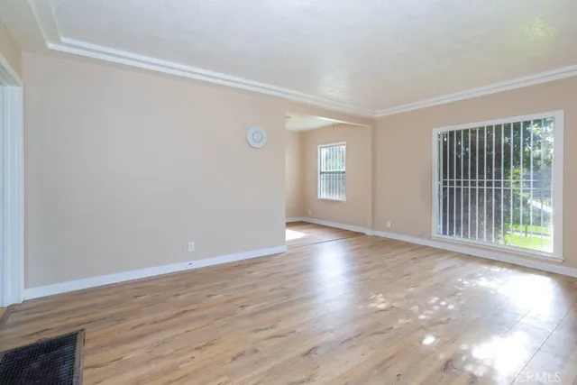 a view of a room with wooden floor and windows