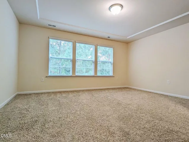 a spacious bathroom with a double vanity sink a mirror and a shower