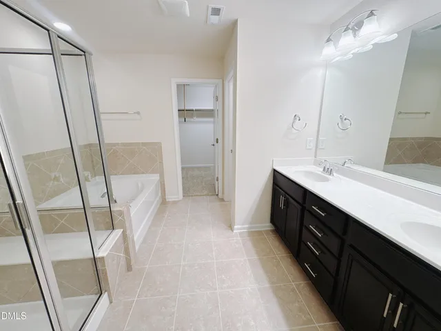 a bathroom with a glass shower door and a sink
