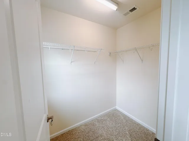 an empty room with a empty space and windows