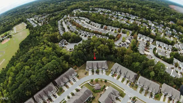 an aerial view of a house with a large trees