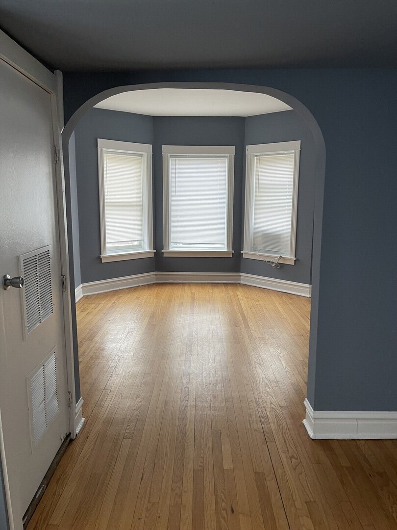 6653 South St Lawrence Avenue, Unit 2 Chicago, IL 60637 - Photo 2 of 7 a view of room with window and wooden floor
