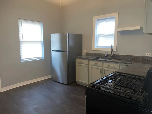 a kitchen with a sink stove and refrigerator