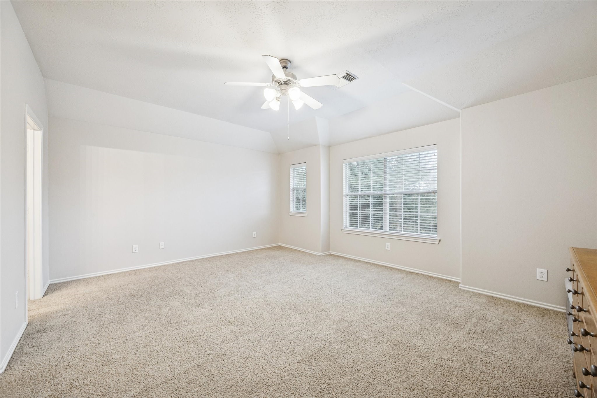 3206 Pearl Bluff Lane Houston, TX 77047 - Photo 11 of 20 an empty room with windows and fan