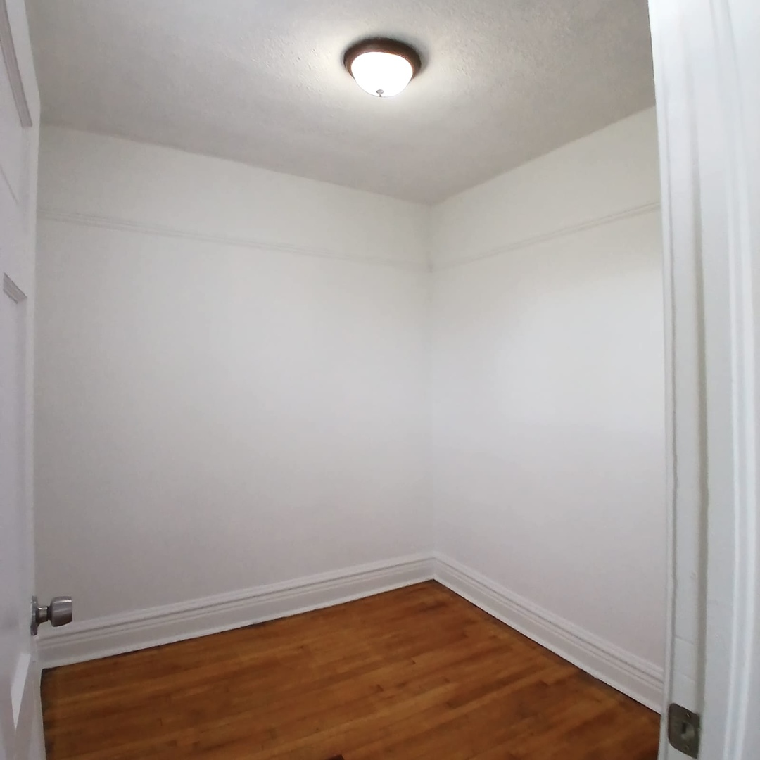 2606 South St Louis Avenue, Unit 5 Chicago, IL 60623 - Photo 11 of 13 a view of an empty room with wooden floor