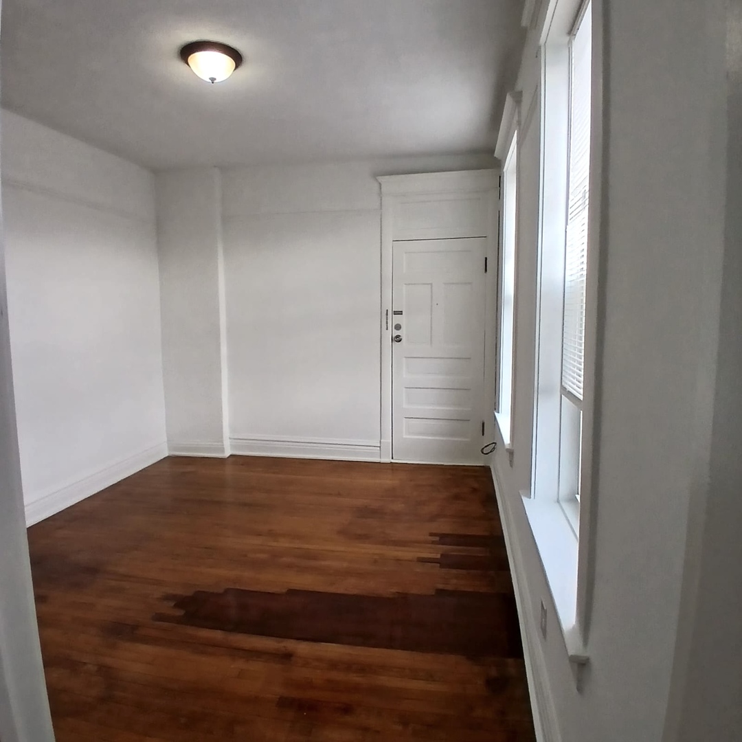 2606 South St Louis Avenue, Unit 5 Chicago, IL 60623 - Photo 2 of 13 wooden floor in an empty room