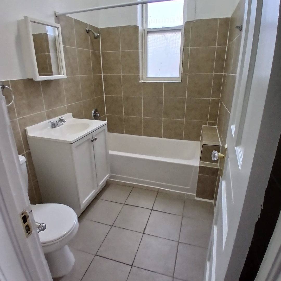 2606 South St Louis Avenue, Unit 5 Chicago, IL 60623 - Photo 7 of 13 a bathroom with a sink toilet and shower