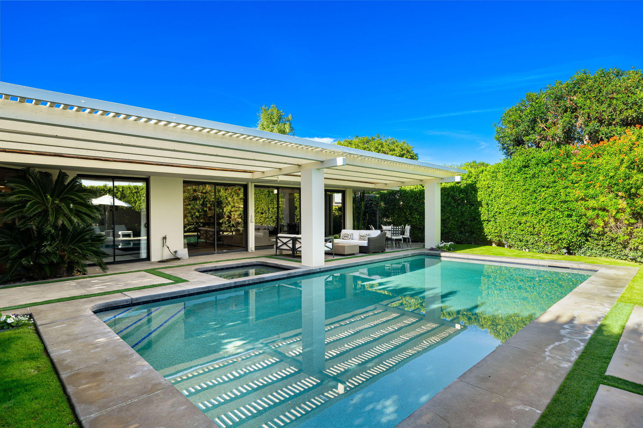 6 Exeter Court Rancho Mirage, CA 92270 - Photo 30 of 54 a view of a house with swimming pool and sitting area