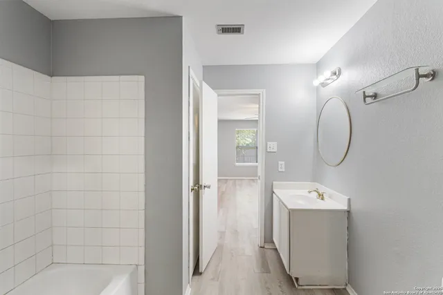 a room with a walk in closet and mirror