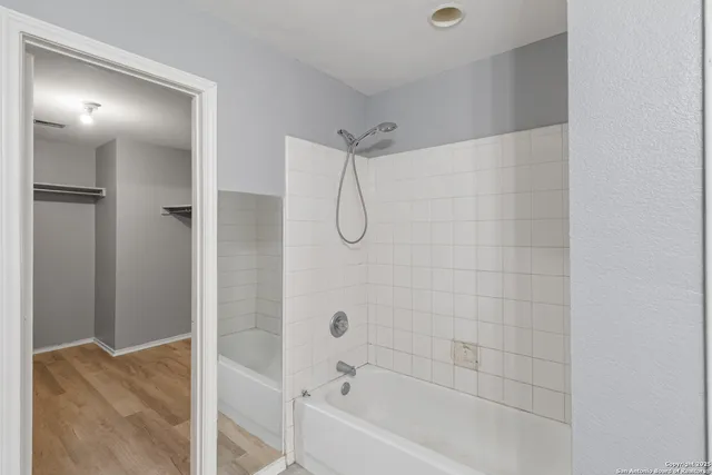 a bathroom with a glass shower door