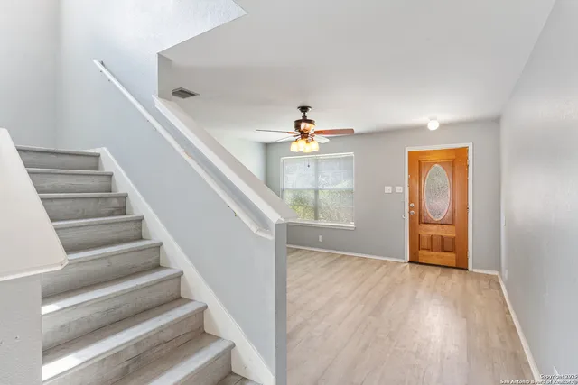 a view of an entryway with wooden floor and livingroom view