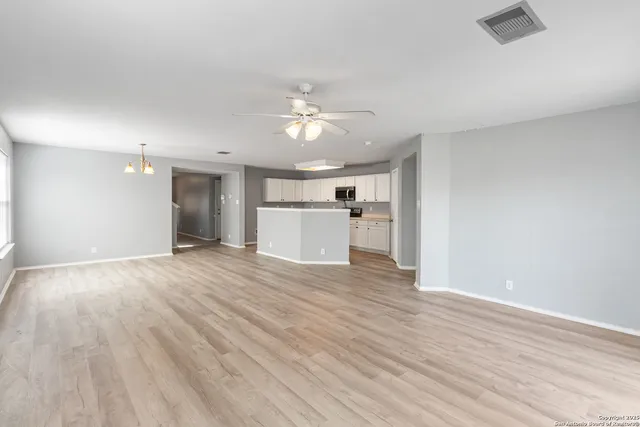 a view of a kitchen with a dishwasher and a stove top oven