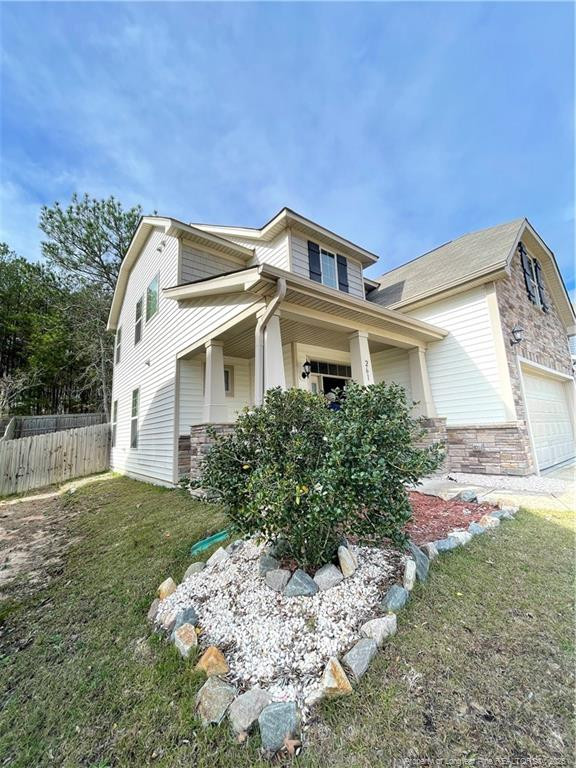 261 River Oaks St Spring Lake Spring Lake, NC 28390 - Photo 2 of 38 a front view of a house with a yard