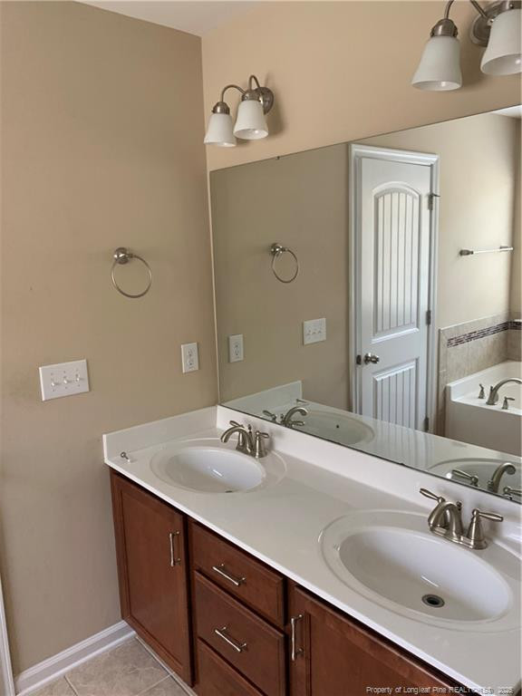 261 River Oaks St Spring Lake Spring Lake, NC 28390 - Photo 29 of 38 a bathroom with a sink and a mirror
