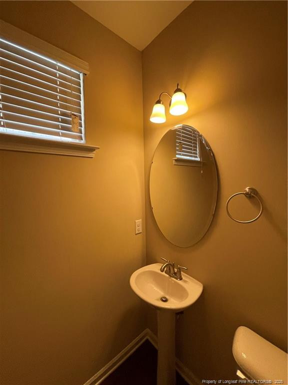 261 River Oaks St Spring Lake Spring Lake, NC 28390 - Photo 32 of 38 a bathroom with a toilet sink and mirror