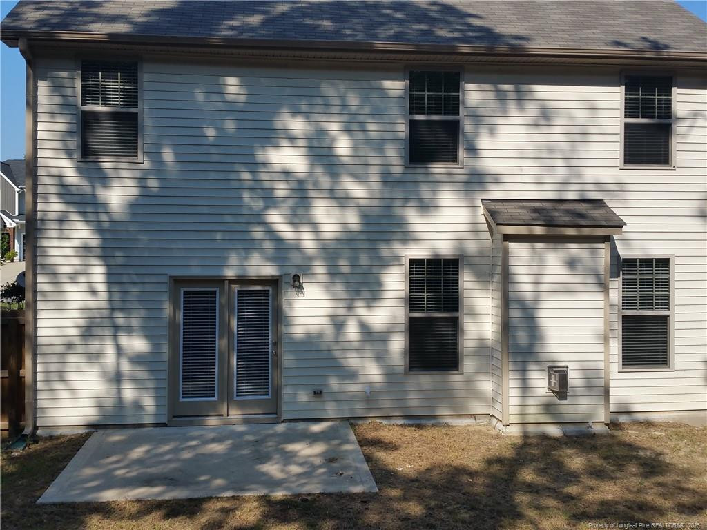 261 River Oaks St Spring Lake Spring Lake, NC 28390 - Photo 35 of 38 a brick house with a small yard