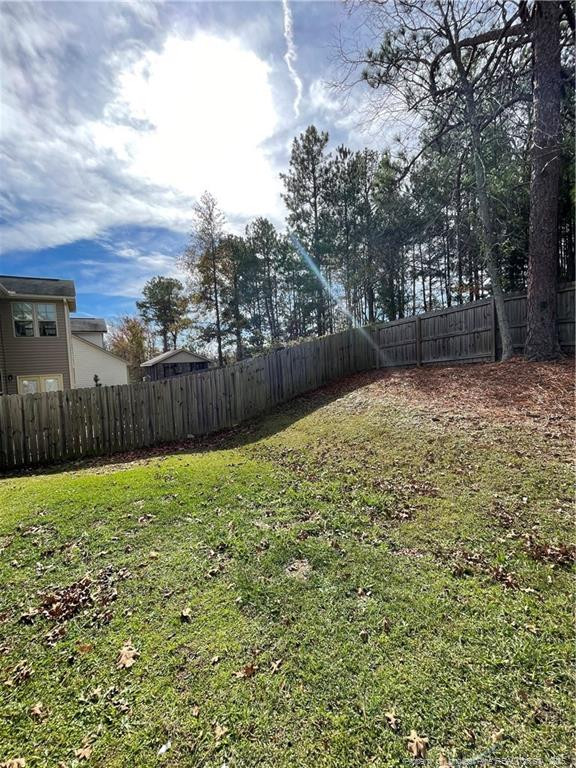 261 River Oaks St Spring Lake Spring Lake, NC 28390 - Photo 37 of 38 a view of a yard with wooden fence