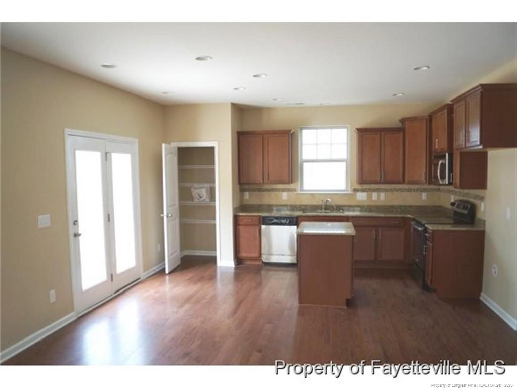 261 River Oaks St Spring Lake Spring Lake, NC 28390 - Photo 9 of 38 a kitchen with a refrigerator and a stove top oven
