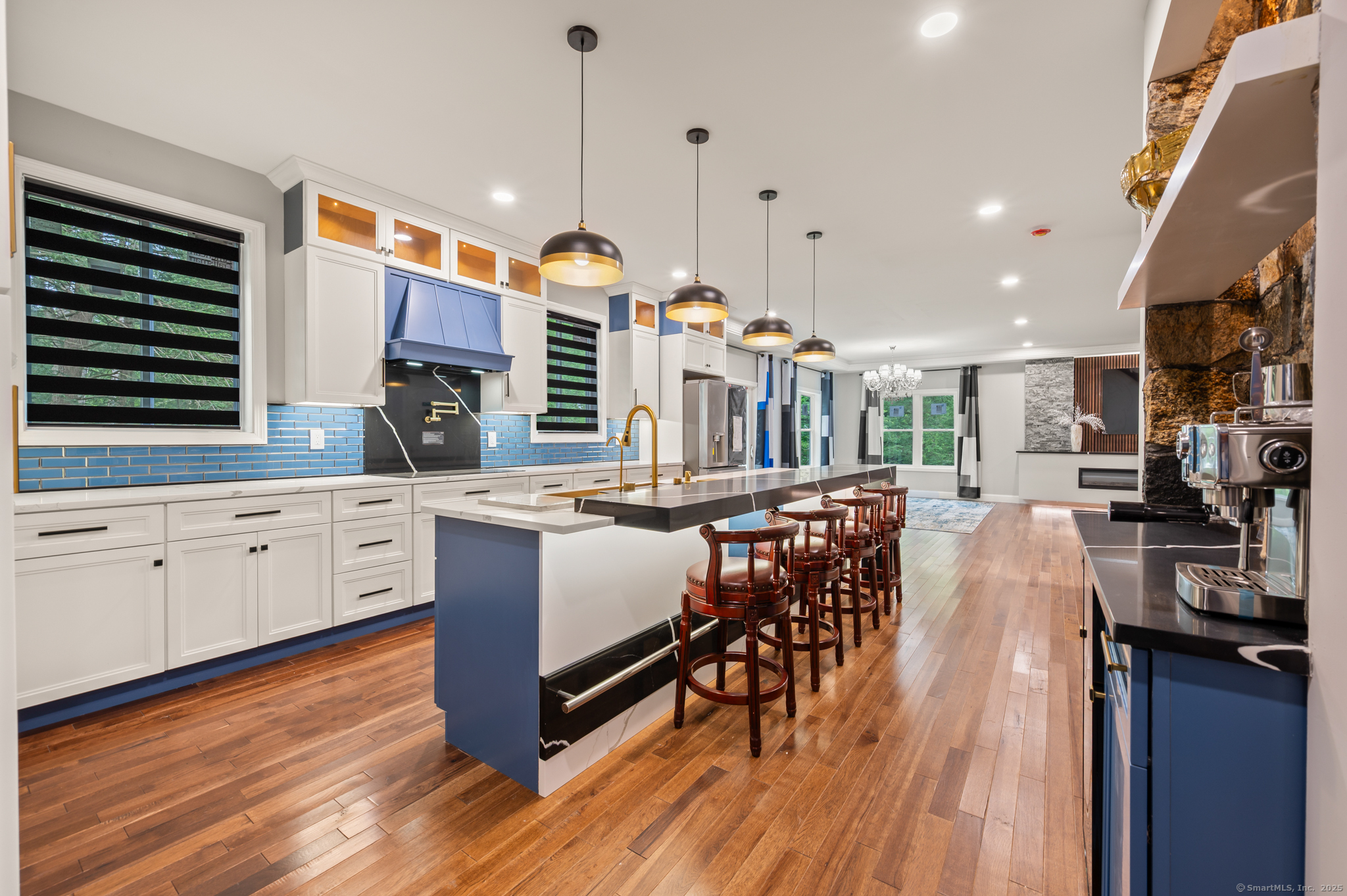 370 West Mountain Road West Simsbury, CT 06092 - Photo 13 of 39 a kitchen with stainless steel appliances kitchen island granite countertop a stove a sink a refrigerator and a dining table with wooden floor