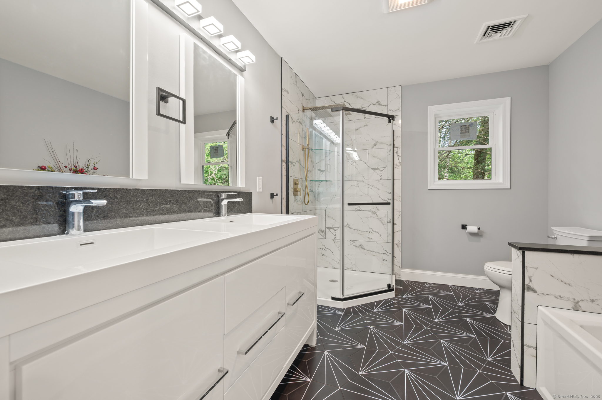 370 West Mountain Road West Simsbury, CT 06092 - Photo 28 of 39 a spacious bathroom with a shower sink and mirror