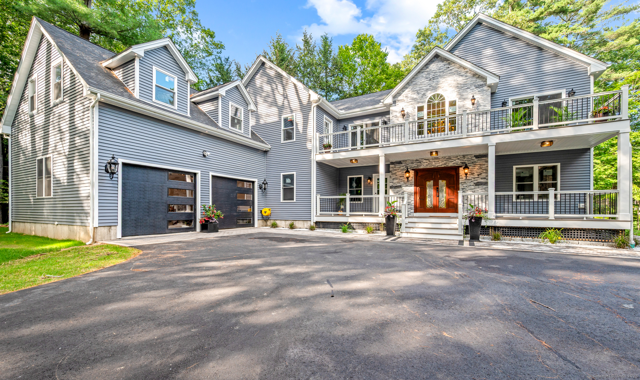 370 West Mountain Road West Simsbury, CT 06092 - Photo 38 of 39 a view of a white house with large windows and a large tree