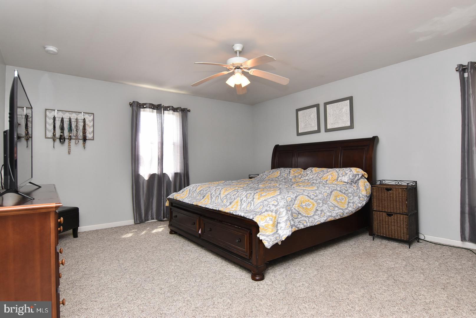 24531 Shortly Road Georgetown, DE 19947 - Photo 22 of 30 a bedroom with a bed and a chandelier