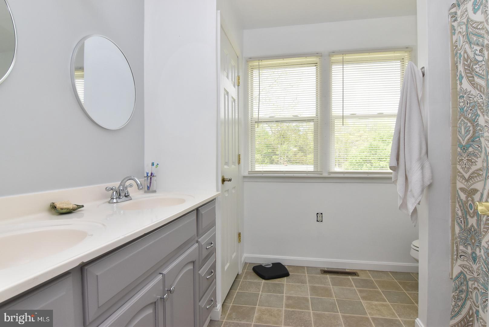 24531 Shortly Road Georgetown, DE 19947 - Photo 24 of 30 a bathroom with a sink and a mirror