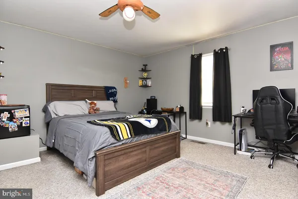 a bedroom with bed and a chandelier
