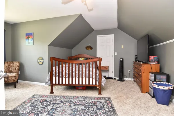 a bedroom with furniture and a rug