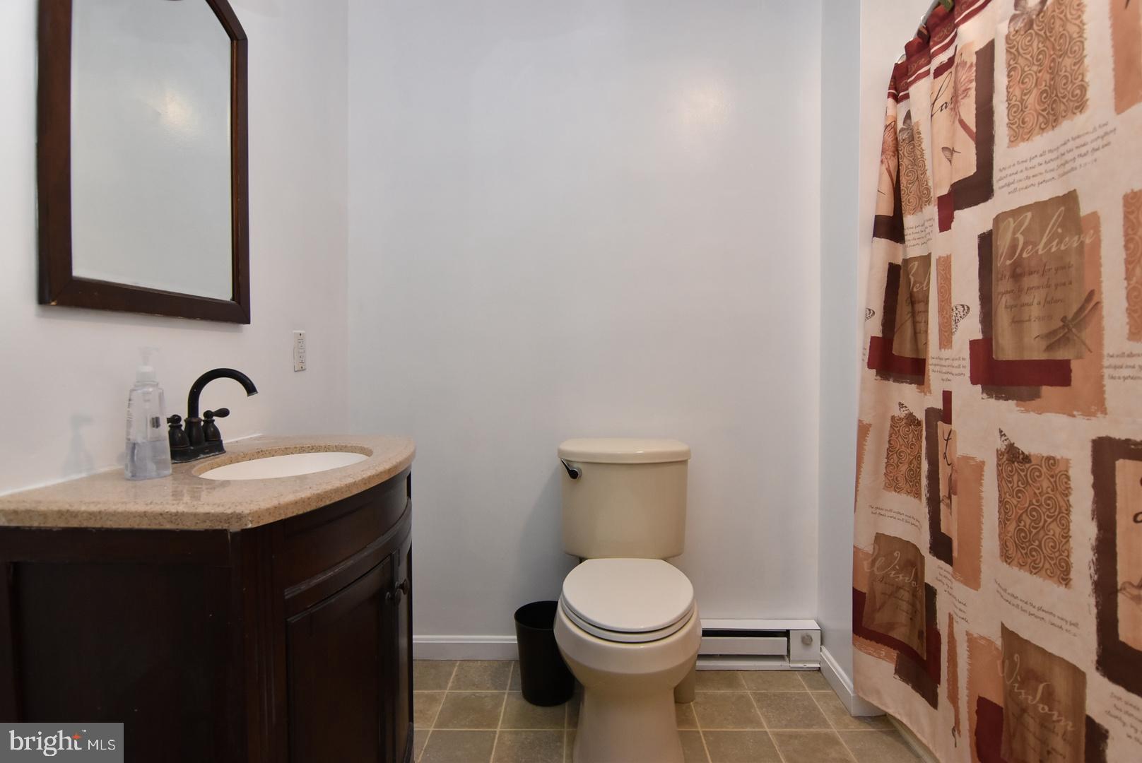 24531 Shortly Road Georgetown, DE 19947 - Photo 30 of 30 a bathroom with a toilet a sink and mirror