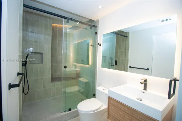 a bathroom with a sink toilet and shower