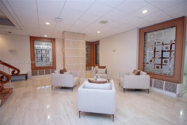 a living room with furniture and large windows