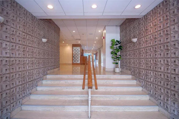 a view of entryway with a front door and wooden floor