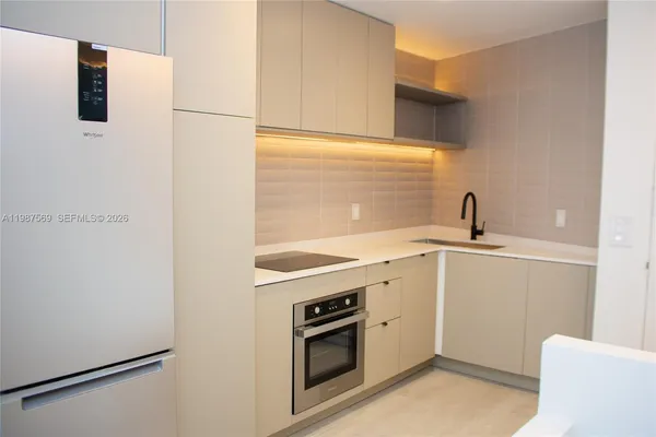 a view of a kitchen with a sink dishwasher and a microwave