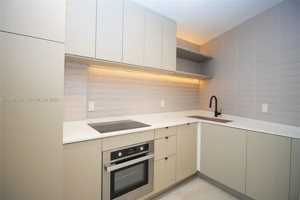 a kitchen with a sink cabinets and appliances