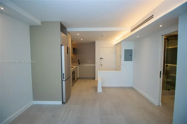 a view of a big room with closet and windows