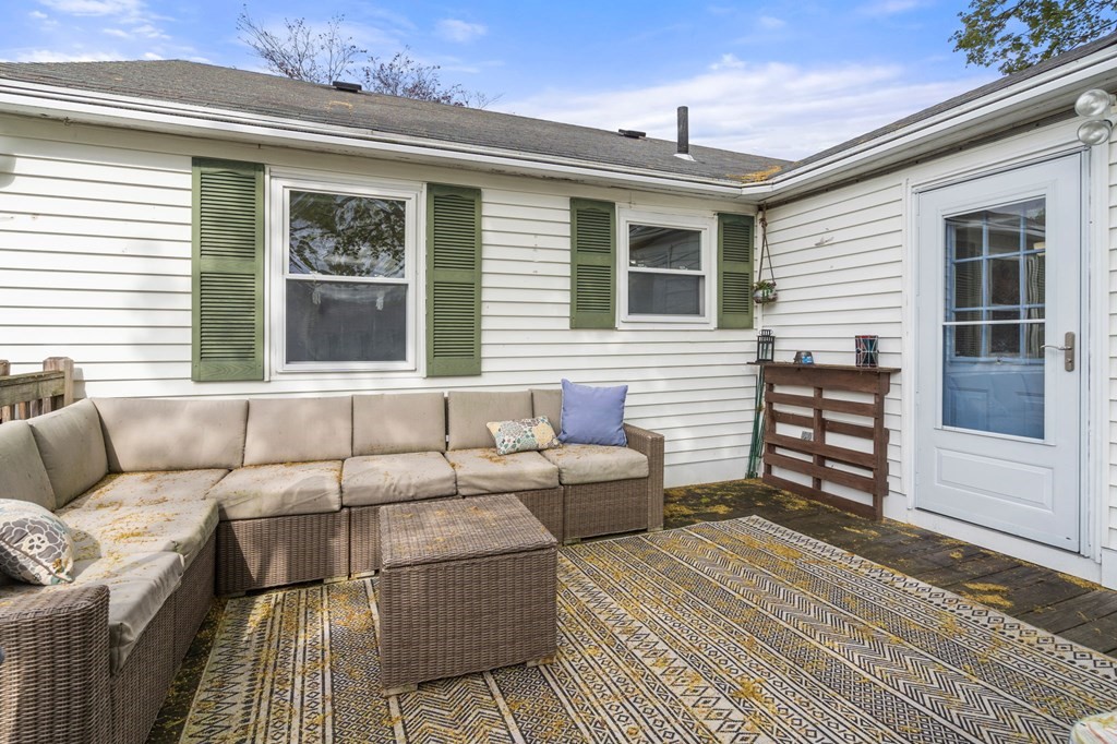172 Circle Drive Waltham, MA 02452 - Photo 19 of 23 a view of a patio with couches and a dining table and chairs with wooden floor