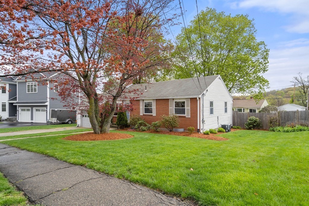 172 Circle Drive Waltham, MA 02452 - Photo 3 of 23 a front view of a house with a yard and trees
