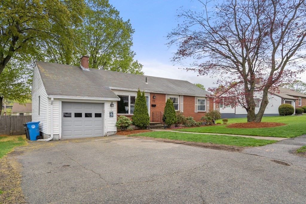 172 Circle Drive Waltham, MA 02452 - Photo 4 of 23 a front view of a house with a yard and garage