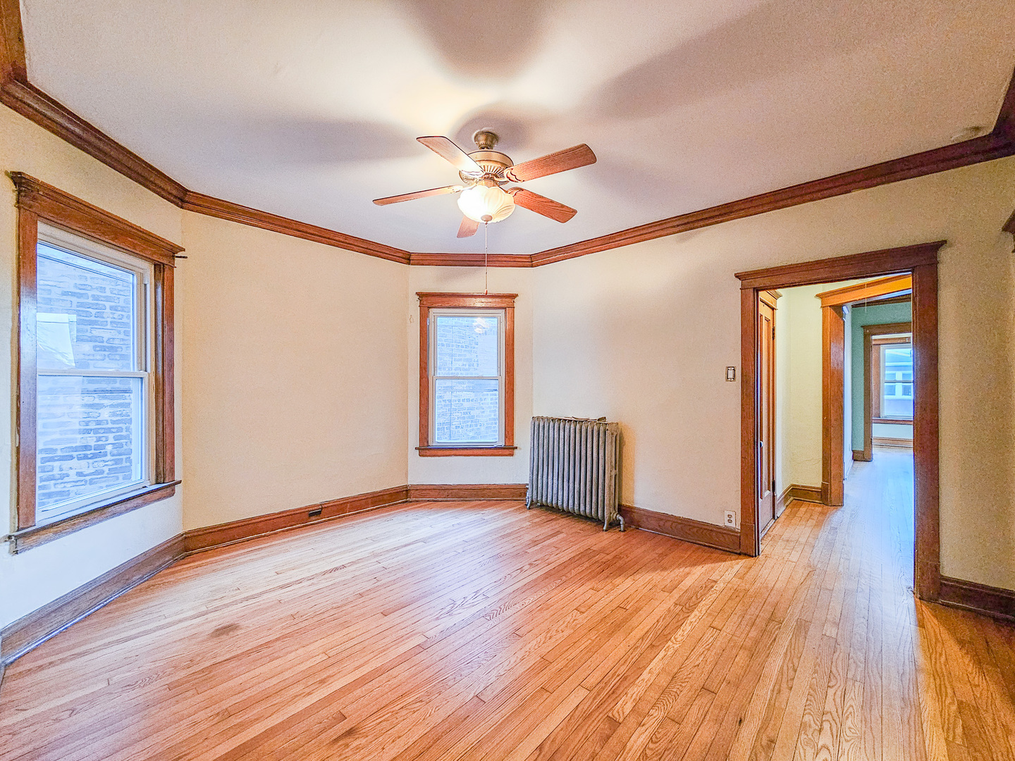 3338 West Cullom Avenue, Unit 2 Chicago, IL 60618 - Photo 6 of 15 a view of an empty room with wooden floor and a window