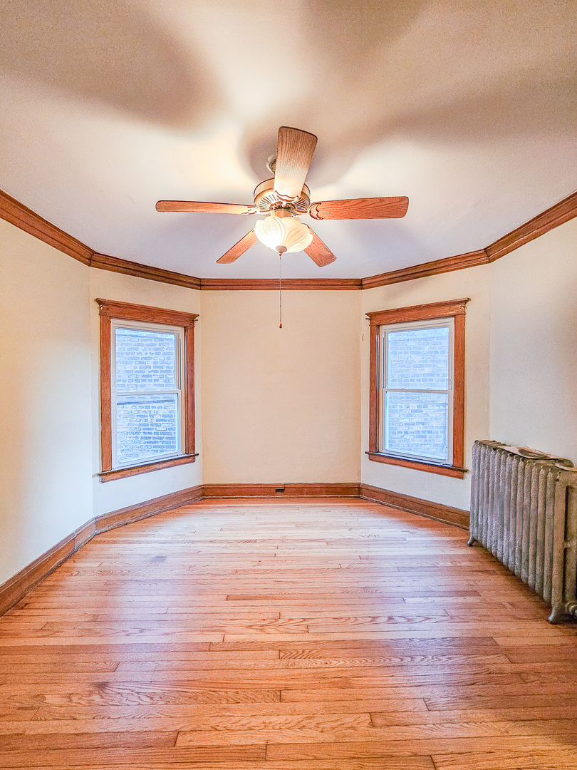 3338 West Cullom Avenue, Unit 2 Chicago, IL 60618 - Photo 7 of 15 a view of livingroom with hardwood floor and a ceiling fan