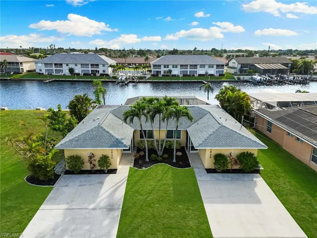 an aerial view of a house with garden space and lake view
