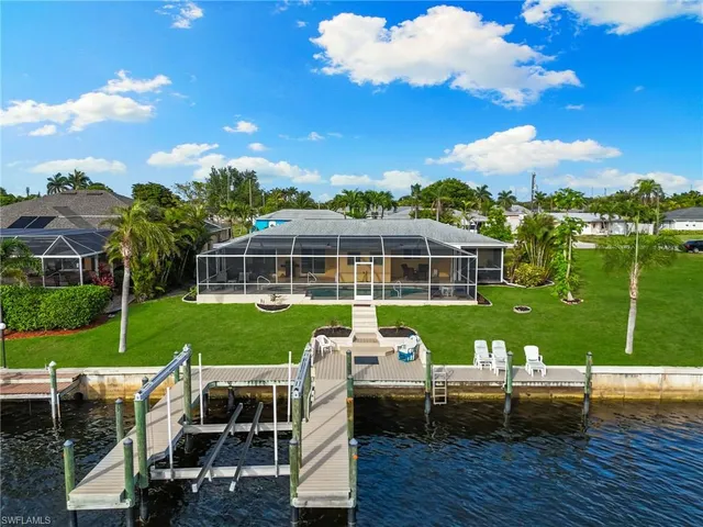 a view of a house with backyard porch and sitting area