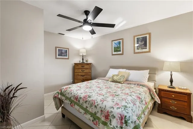 a bedroom with a bed and a potted plant