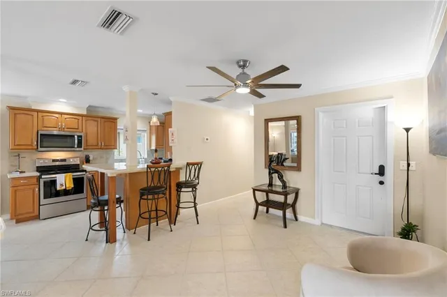a view of a dining room with furniture and a kitchen