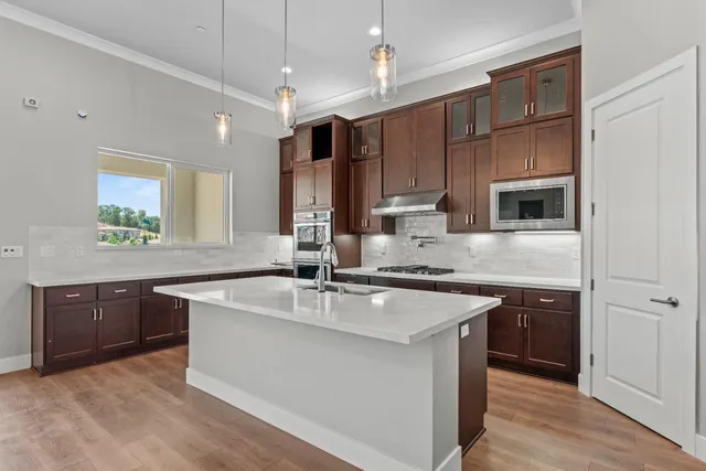 a kitchen with granite countertop a stove and a sink
