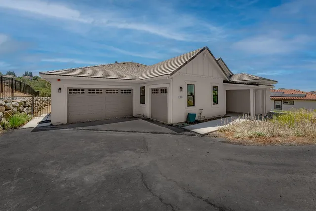 a view of a house with a yard and garage