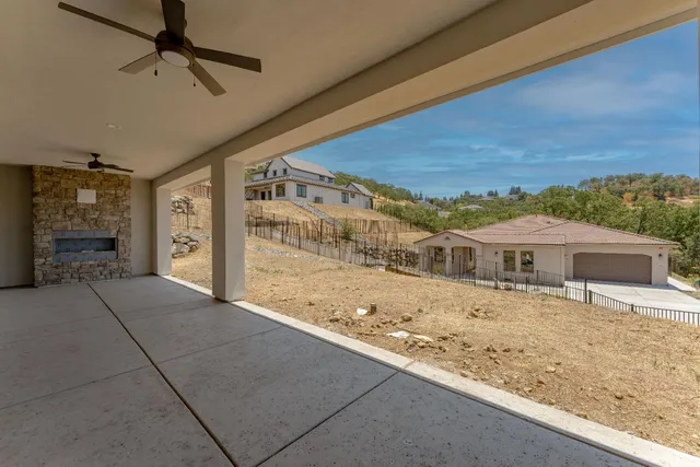 a view of a big yard with wooden fence
